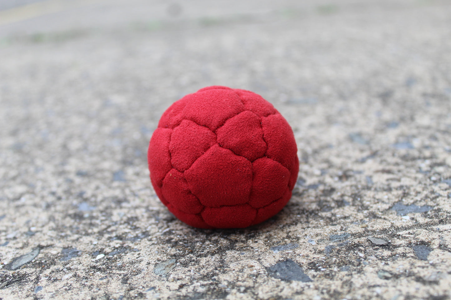 Close-up of 32 panel thud juggling ball showing panel detail in red
